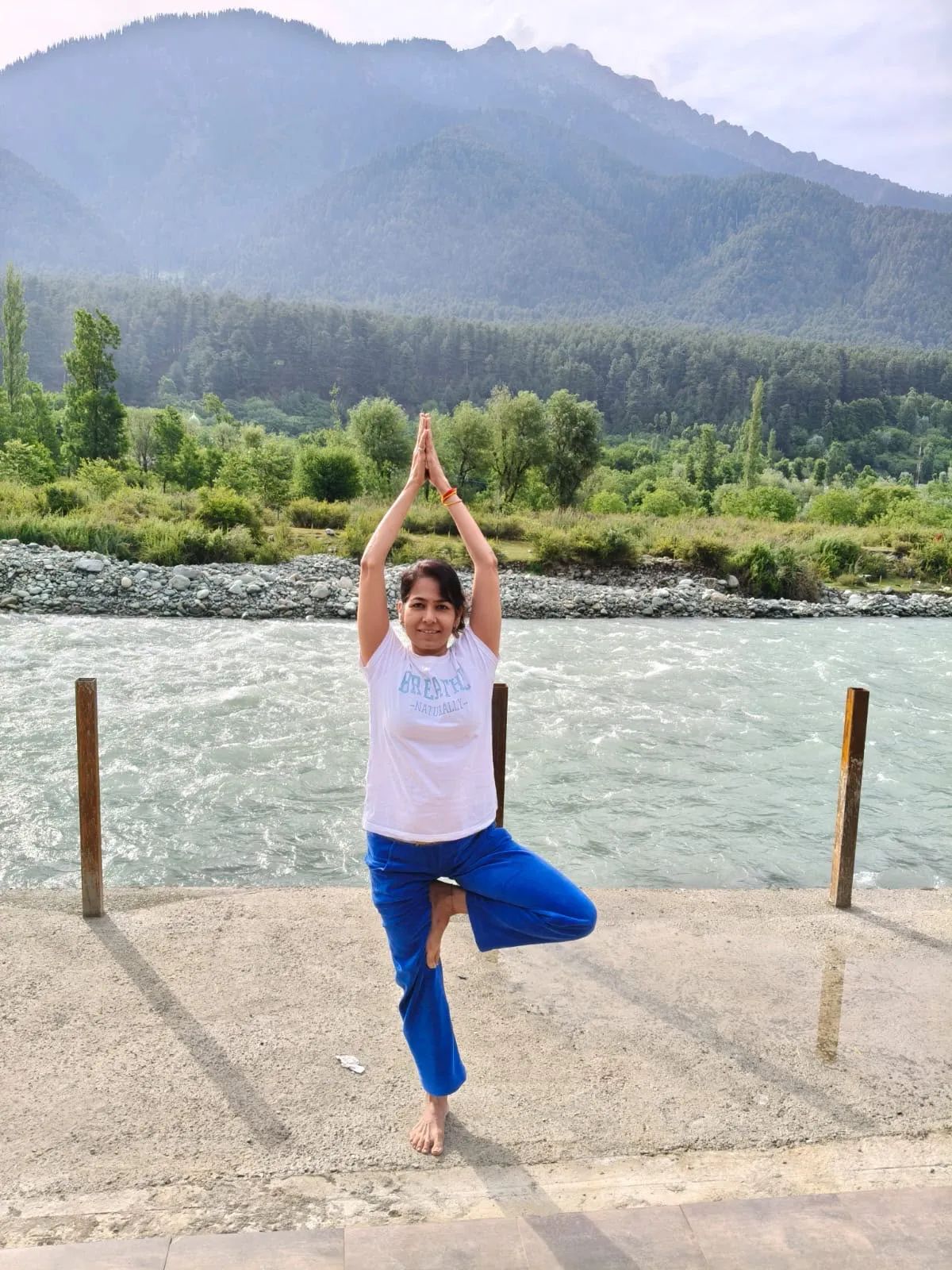 Vin in tree pose beside a mountain river